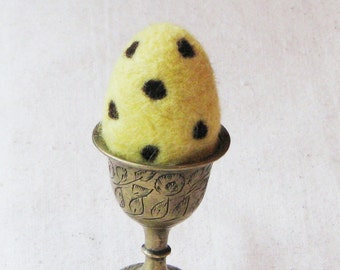 Easter egg, needle felted from wool in soft pastel yellow with brown polka dots