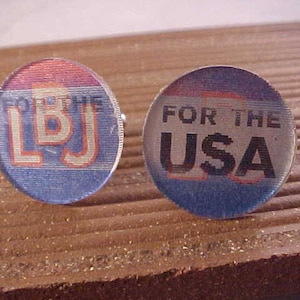 May include: Two round, blue and red buttons with white lettering. One button says "FOR THE USA" and the other says "LBJ".