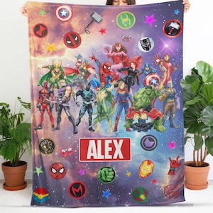 May include: A rectangular fleece blanket featuring a vibrant space-themed background with numerous Marvel superhero characters, including Spider-Man, Thor, and Hulk. The center displays a red rectangular label with the white text ALEX.
