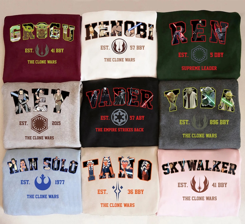 May include: Nine sweatshirts with Star Wars character names in a collegiate style. The sweatshirts are in various colors, including maroon, white, green, gray, black, light blue, beige, and pink. Each sweatshirt features a character name, the phrase "EST." and "The Clone Wars".