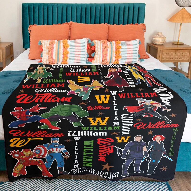 May include: Black blanket featuring various superhero illustrations and the name "William" in multiple fonts and colors. The blanket showcases characters like Spider-Man, Hulk, and Captain America, with a star pattern.