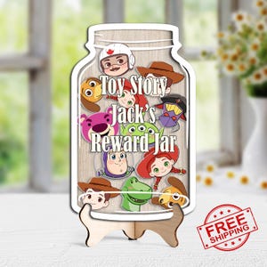 May include: A wooden reward jar featuring characters from the movie Toy Story. The jar-shaped sign has the text "Toy Story Jack's Reward Jar" and includes images of Woody, Buzz Lightyear, and other characters. The sign is displayed on a wooden stand.