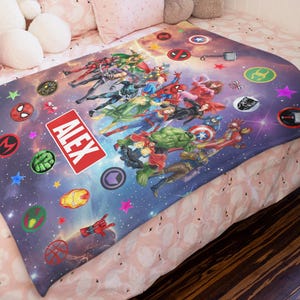 May include: A rectangular fleece blanket featuring a cosmic purple and blue space background with various Marvel superhero characters, circular character icons, and colorful stars. A prominent red rectangular label displays the name ALEX in white.