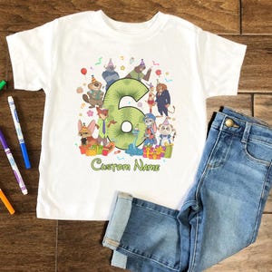 May include: A white short-sleeve t-shirt featuring a large green number six surrounded by various cartoon animal characters wearing party hats. The graphic includes colorful gift boxes, confetti, and the text Custom Name printed in green below the design.