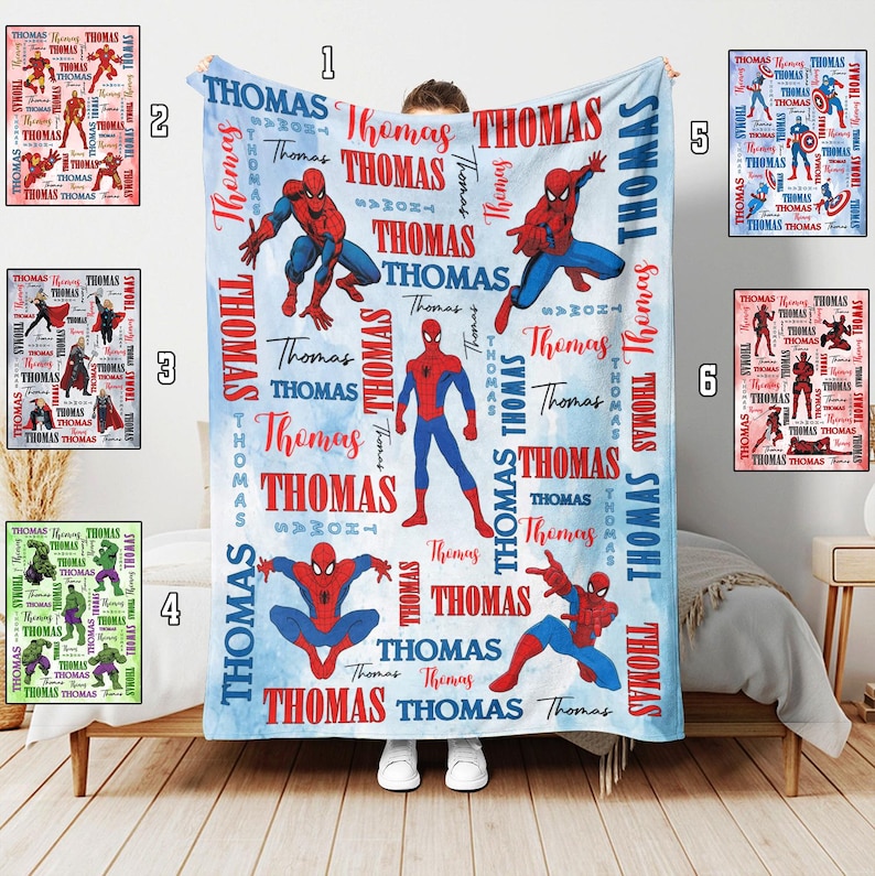 May include: A personalized blue and white blanket featuring the name "Thomas" in red and white, along with illustrations of Spider-Man in various poses. The blanket is a soft, cozy item, perfect for a bedroom or living room.
