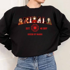May include: Black sweatshirt with red text and graphics. The word "AMIDALA" is arched across the top, with images of characters inside the letters. Below, the text reads "EST. 46 BBY QUEEN OF NABOO" with a red symbol.