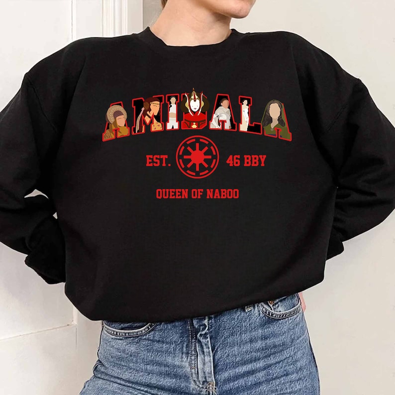 May include: Black sweatshirt with red text and graphics. The word "AMIDALA" is arched across the top, with images of characters inside the letters. Below, the text reads "EST. 46 BBY QUEEN OF NABOO" with a red symbol.