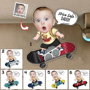 May include: A cartoon image of a baby riding a skateboard, with the text "Drive Safe DADDY" in a speech bubble. The baby is wearing a yellow shirt and black shorts. The skateboard has a red and black design.