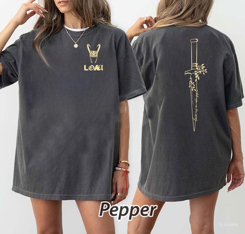 May include: Dark gray t-shirt with gold-colored graphics. The front features a stylized design and the word "LOKI". The back displays a dagger design with floral accents and the text "wedding in trust". The word "Pepper" is at the bottom.