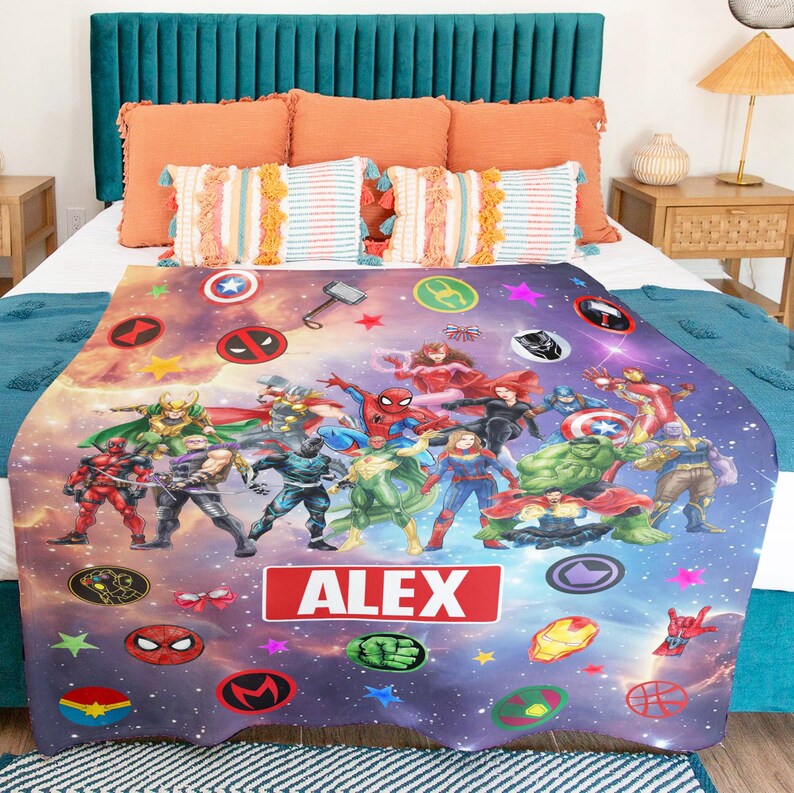 May include: A rectangular fleece blanket featuring a vibrant cosmic background filled with various superhero characters and icons. The center displays a prominent red rectangular graphic with the white text ALEX. The design includes stars and circles.