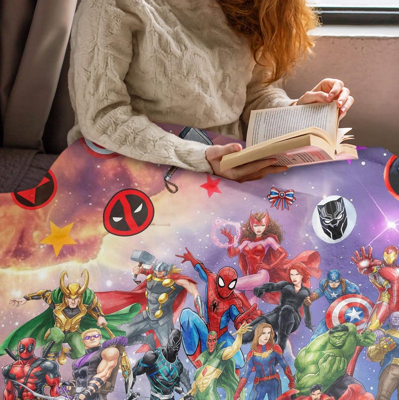 May include: A soft throw blanket featuring a vibrant, colorful collage of various Marvel superheroes including Spider-Man, Thor, Iron Man, Hulk, Black Widow, and Loki, set against a cosmic, starry background with scattered red and yellow stars.