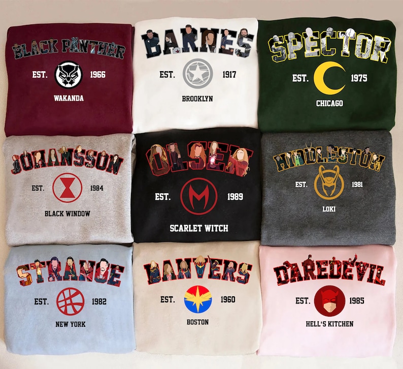 May include: Nine sweatshirts in various colours, including maroon, white, green, grey, black, light blue, and pink. Each sweatshirt displays a name, year, and location. The designs feature characters and logos. Measurements are not included.