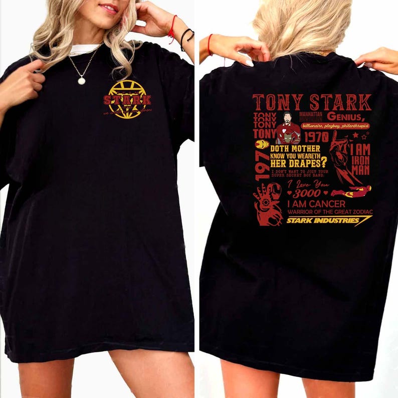 May include: Black t-shirt featuring a graphic of Tony Stark with text including "TONY STARK", "1970", and "I AM IRON MAN". The front of the shirt displays the Stark Industries logo. The shirt is a casual wear item.