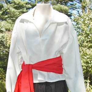 May include: A white long-sleeved shirt with a wide collar and a red sash tied around the waist.