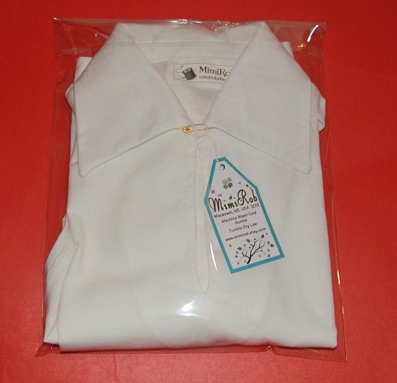 May include: White collared shirt in a clear plastic bag with a tag that reads "Mimi Rob Wiecasses, ME USA 2012 Machine Wash Cold Gentle Tumble Dry Low www.mimirob.etsy.com"