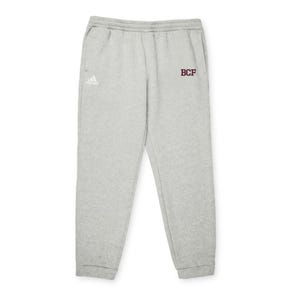 May include: Light grey sweatpants with an elastic waistband and cuffs. The Adidas logo is on the left side, and the letters "BCF" are on the right side in maroon.