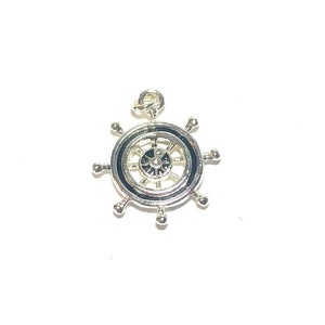 May include: Silver ship wheel charm pendant with a detailed design.
