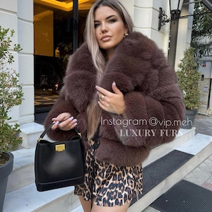 Brown luxury womens fur coat made of natural Finnish fox fur with beautiful collor. Winter woman furs coat.