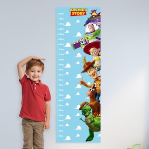May include: A blue height chart featuring characters from "Toy Story" with a measurement scale in centimeters. The chart has a light blue background with white clouds. A young child stands next to the chart, measuring their height.