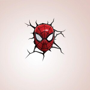 May include: A red and black Spider-Man mask design, appearing to break through a wall. The mask features white eye lenses and a web pattern. The surrounding wall is a light pink colour.