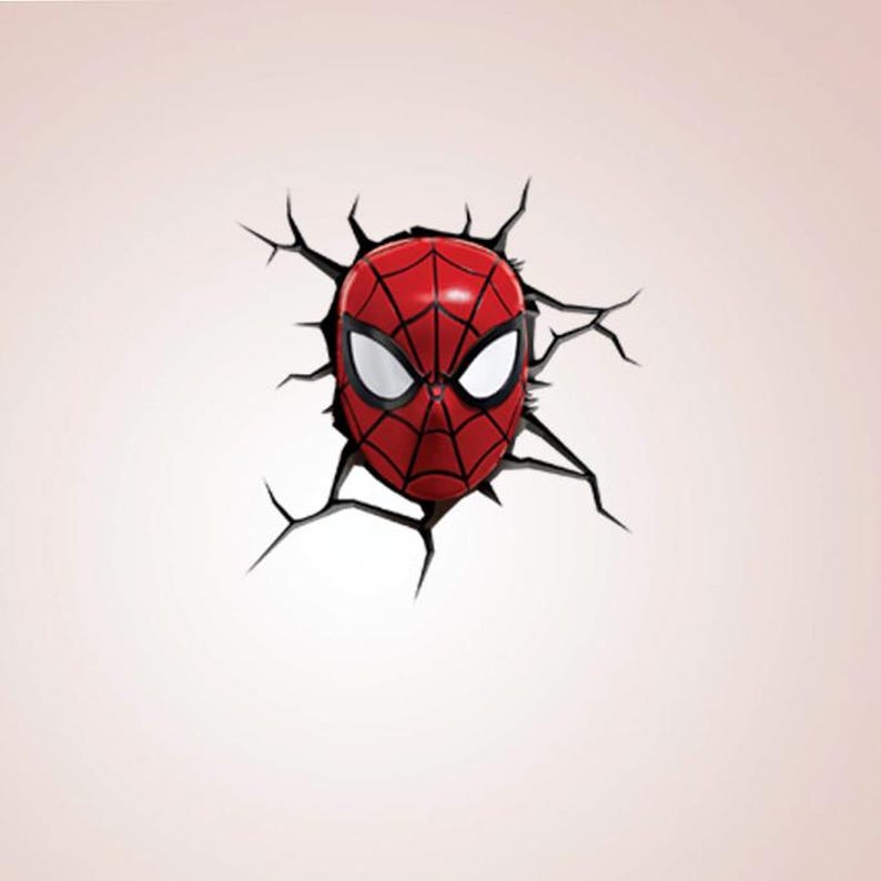 May include: A red and black Spider-Man mask design, appearing to break through a wall. The mask features white eye lenses and a web pattern. The surrounding wall is a light pink colour.