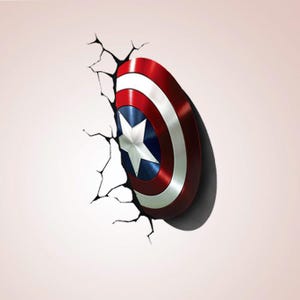 May include: A Captain America shield design, with a red, white, and blue colour scheme and a white star in the centre. The shield appears to be breaking through a wall, with cracks emanating from the point of impact. The shield has a metallic sheen.