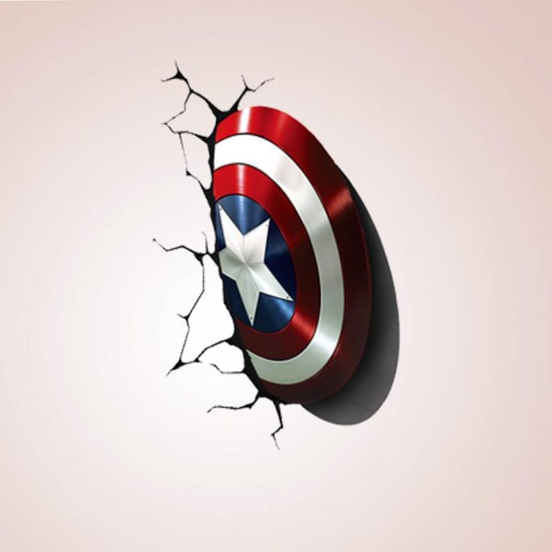 May include: A Captain America shield design, with a red, white, and blue colour scheme and a white star in the centre. The shield appears to be breaking through a wall, with cracks emanating from the point of impact. The shield has a metallic sheen.