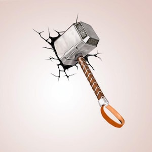 May include: A silver and brown hammer with a leather-wrapped handle and an orange loop. The hammer appears to be breaking through a wall, with cracks radiating outwards. The hammer's head has engraved details.