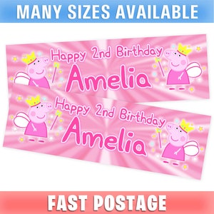 May include: Two pink birthday banners with the text "Happy 2nd Birthday Amelia" and a cartoon pig character with a crown and wand. The banners have a radial burst design and the text "Many Sizes Available" at the top.