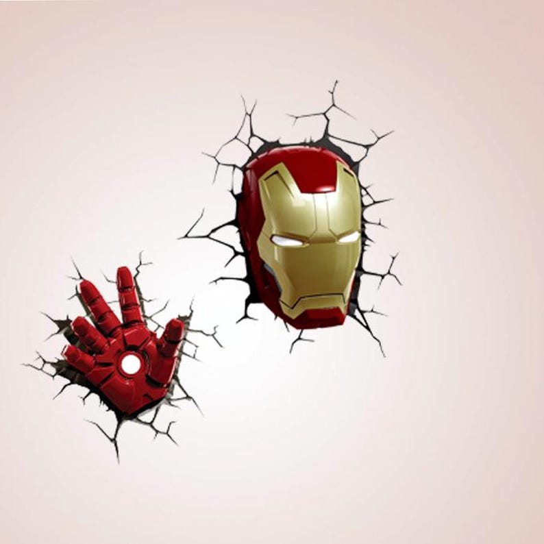 May include: A red and gold Iron Man helmet and hand design, appearing to break through a wall, with a cracked effect. The helmet features a gold faceplate and red details. The hand is red with a white central circle.