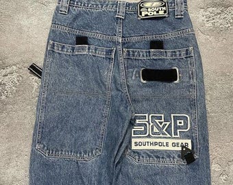 May include: Light blue denim jeans with the "South Pole" logo patch on the back waistband. The back pockets feature black accents and the "S&P Southpole Gear" logo. The jeans have a classic, relaxed fit.