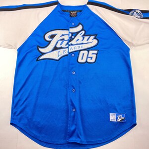 May include: Blue baseball jersey with white sleeves and black trim. The jersey features the text "Fubu League 05" in white and blue. A small patch with the Fubu logo is on the bottom.