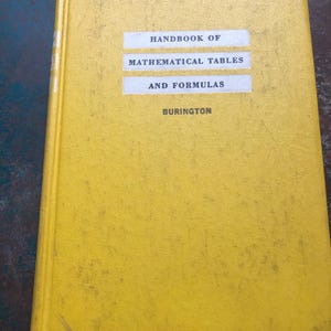 May include: A yellow hardcover book titled Handbook of Mathematical Tables and Formulas by Burington. The front cover features white rectangular labels with black text, displaying the title and author name in a clear, centered layout.