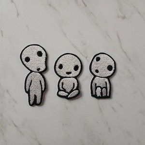 May include: A trio of ceramic mugs with a speckled, matte finish in cream, light grey, and dark grey. Each mug has a simple, modern design and a rounded handle. Ideal for tea or coffee.