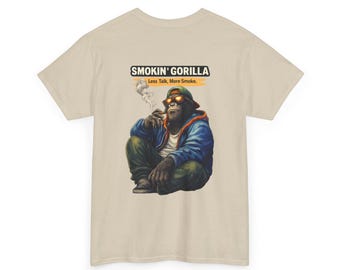 May include: Beige t-shirt featuring a graphic of a gorilla wearing sunglasses and a blue jacket, smoking. The text "SMOKIN' GORILLA" and "Less Talk, More Smoke" are printed above the gorilla.