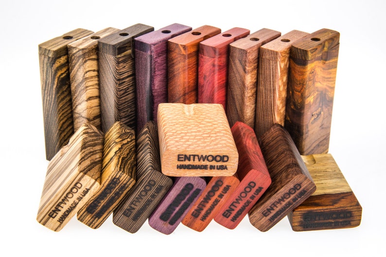 May include: A collection of wooden boxes with different wood grain patterns and colors. The boxes are stacked in a staggered pattern and have the text "ENTWOOD HANDMADE IN USA" printed on them.