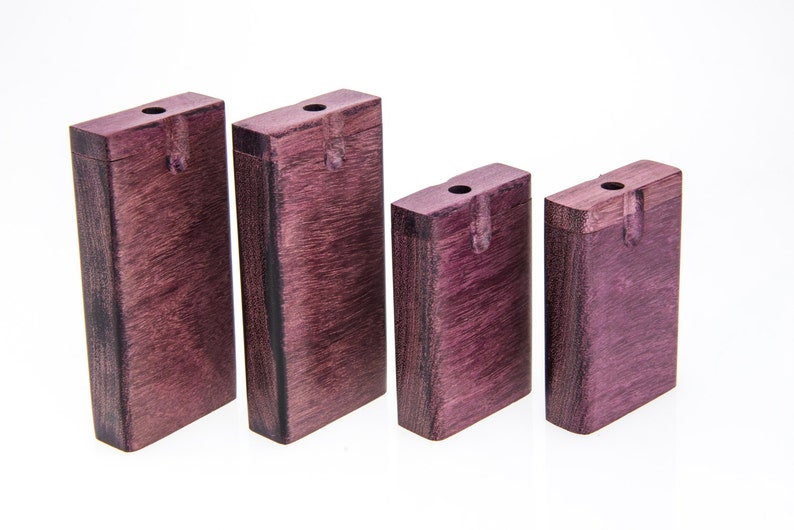 May include: Four wooden boxes with lids, all the same size and shape. The boxes are a deep purple color and have a natural wood grain.