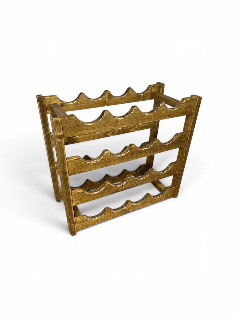 May include: A wooden wine rack with a golden-brown finish. The rack is designed to hold multiple bottles, with curved slots to cradle each bottle. The structure is made of interlocking wooden pieces, creating a sturdy and decorative storage solution.