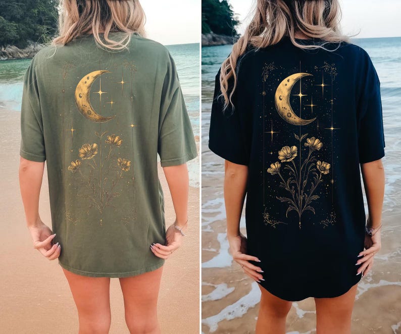 May include: Two t-shirts, one olive green and one navy blue, each featuring a gold crescent moon, stars, and floral design on the back. The shirts are short-sleeved and appear to be made of a soft material.