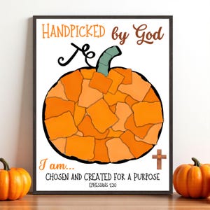 May include: A framed print with a pumpkin design made of orange and tan shapes. The text reads "HANDPICKED by God" and "I am... CHOSEN AND CREATED FOR A PURPOSE" with a cross and the Bible verse Ephesians 2:10.