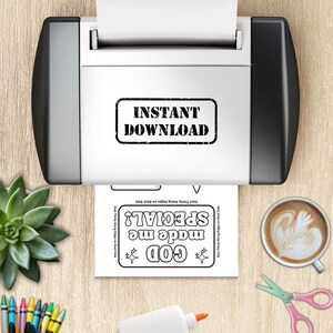 May include: A white printer with black side panels features the text INSTANT DOWNLOAD. A printed paper sheet below displays the text GOD made me SPECIAL! with star icons, alongside a green succulent, a coffee cup, and colorful crayons.