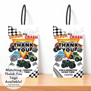 May include: Two white gift bags with black handles, featuring a monster truck theme. The bags have the text "SMASH AND CRASH THANK YOU" and images of colourful monster trucks. One bag says "Matching Thank You Tags Available!" and the other says "For a Monster Good Time! -Easton."