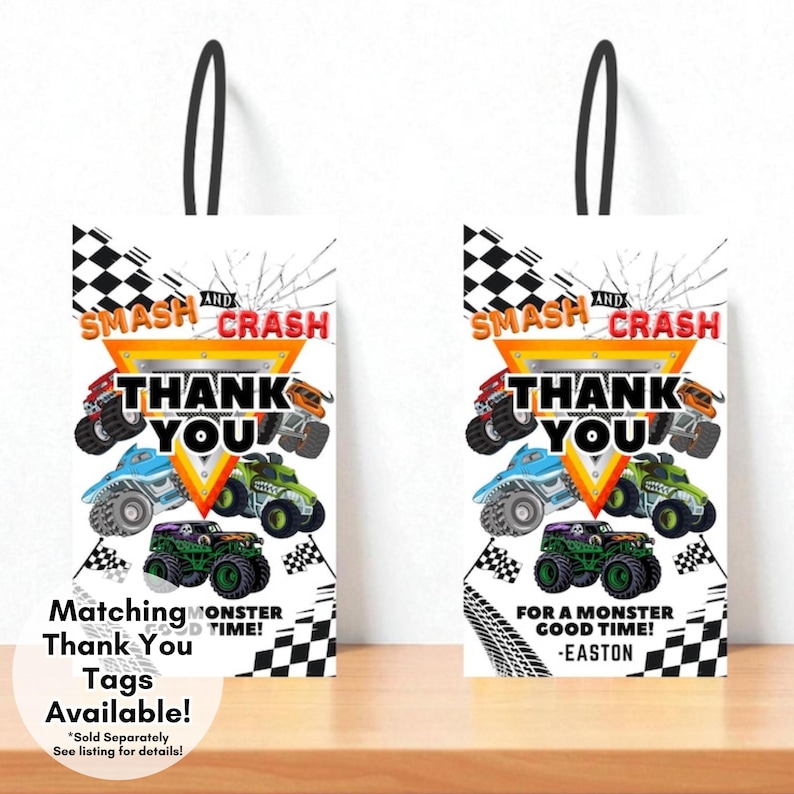 May include: Two white gift bags with black handles, featuring a monster truck theme. The bags have the text "SMASH AND CRASH THANK YOU" and images of colourful monster trucks. One bag says "Matching Thank You Tags Available!" and the other says "For a Monster Good Time! -Easton."