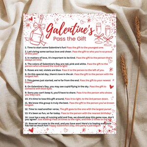 May include: A red and white printable card with the text "Galentine's Pass the Gift" and a list of instructions for a game. The instructions include passing the gift to the youngest person, the person who is always on time, the person dressed the brightest, the person to the left, the person with the longest hair, the person with blue eyes, the person who shows they care, the person to the right, the person you've known the longest, the person with the largest purse, the person with the nearest birthday, and the person who has won the game. The card also includes a red heart with the text "xoxo".