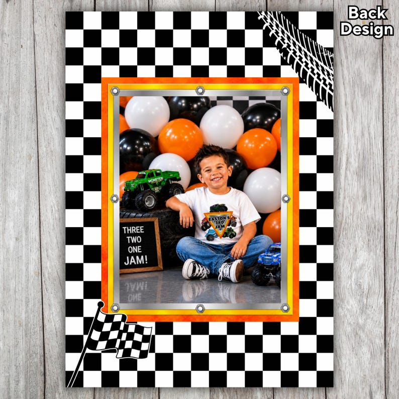 May include: A framed photograph of a young boy wearing a monster truck t-shirt, with orange, black, and white balloons in the background. The frame has an orange and yellow border, set against a black and white chequered background. A chequered flag is in the lower left corner.