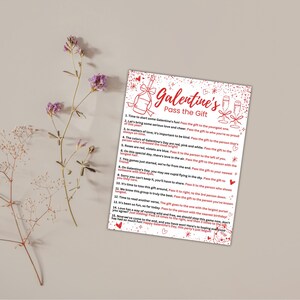 May include: A printable Galentine's Day game card with red and white text on a white background with red glitter. The text reads "Galentine's Pass the Gift" and includes instructions for a game where players pass a gift around the group.