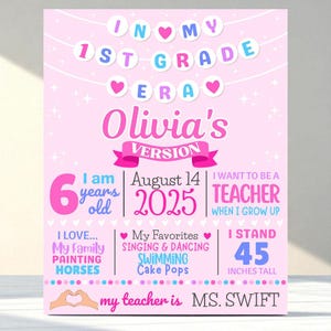 May include: A pink and white 1st Grade sign with the text "In My 1st Grade Era" and "Olivia's Version." It includes details like age, favorite activities, and height (114 cm). The sign also states "I want to be a teacher" and "My teacher is MS. Swift."