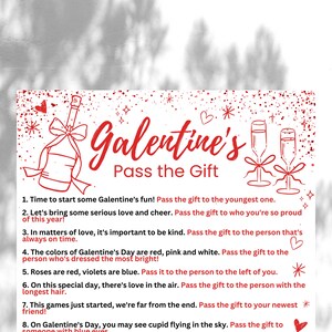 May include: A white card with red text and illustrations of a champagne bottle, two champagne flutes, and stars. The text reads "Galentine's Pass the Gift" and includes eight instructions for a Galentine's Day game.