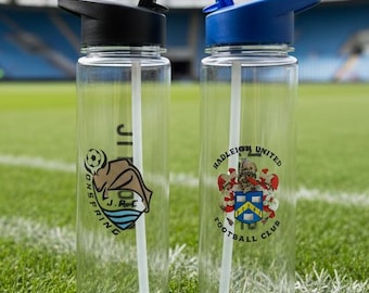 May include: Two clear plastic water bottles with black and blue lids and white straws. One bottle has a logo with a cartoon beaver and the text "J. Park". The other bottle has the text "Hadleigh United Football Club" and a crest.