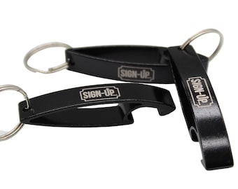 May include: Black bottle opener keychains with silver key rings. Each keychain has the text "SIGN-UP" in white. The bottle openers are made of metal and have a curved design with a bottle opener on one end.
